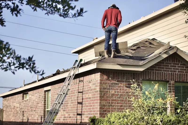 Professional roofer working on a residential roof in Sage Oaks